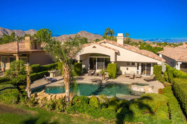 a kitchen with stainless steel appliances granite countertop a stove a sink dishwasher and cabinets with wooden floor