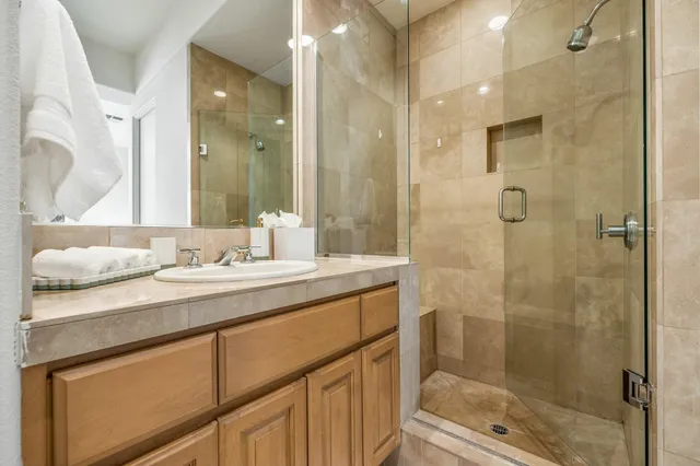 a living room with furniture a flat screen tv and a large window