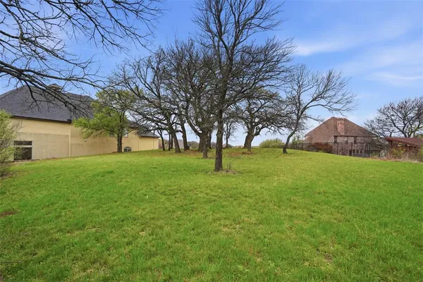 a view of yard with swimming pool and green space