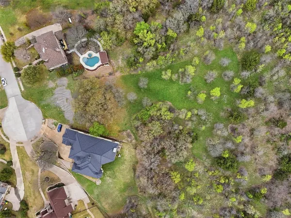 an aerial view of residential houses with outdoor space and river