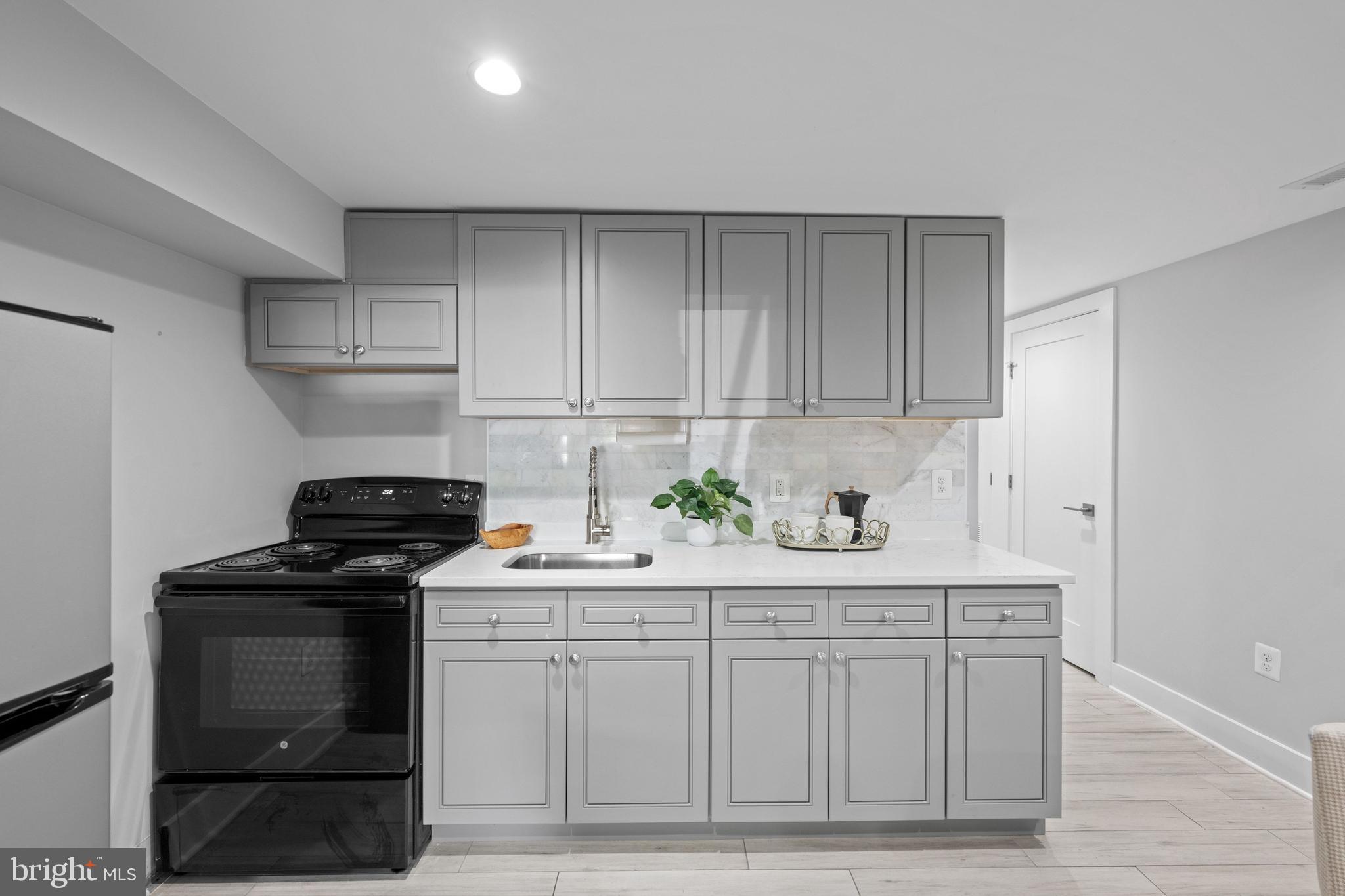 1124 4th Street Northeast Washington, DC 20002 - Photo 22 of 34 a kitchen with white cabinets and appliances