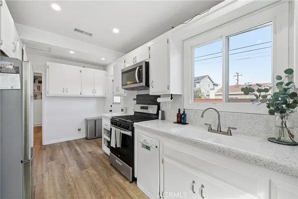 a kitchen with stainless steel appliances sink a microwave and cabinets