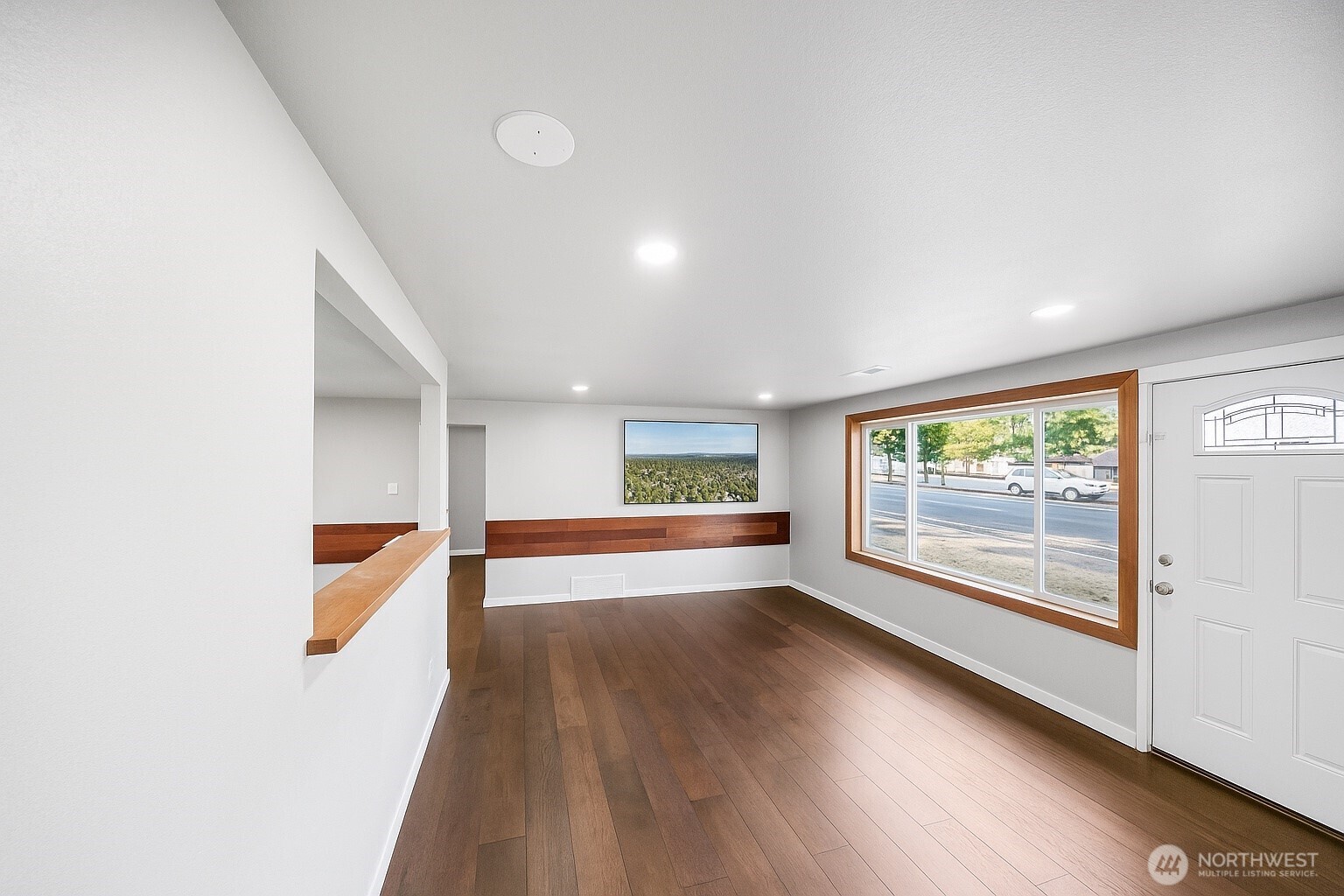 4908 236th Street Southwest Mountlake Terrace, WA 98043 - Photo 11 of 21 a view of an empty room with wooden floor and a window