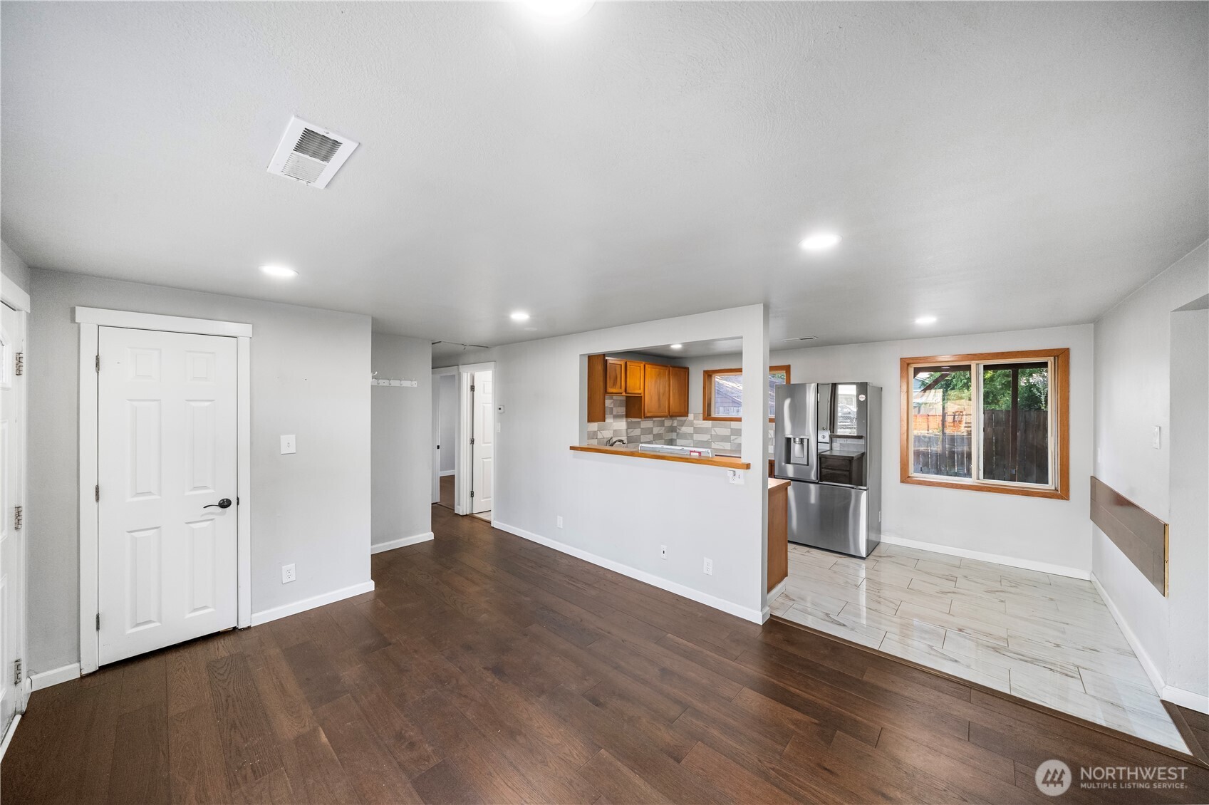 4908 236th Street Southwest Mountlake Terrace, WA 98043 - Photo 3 of 21 an empty room with wooden floor and windows