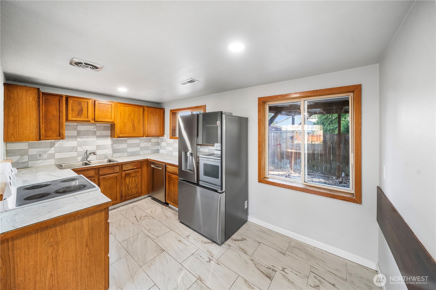 4908 236th Street Southwest Mountlake Terrace, WA 98043 - Photo 5 of 21 a kitchen with stainless steel appliances granite countertop a refrigerator and a sink