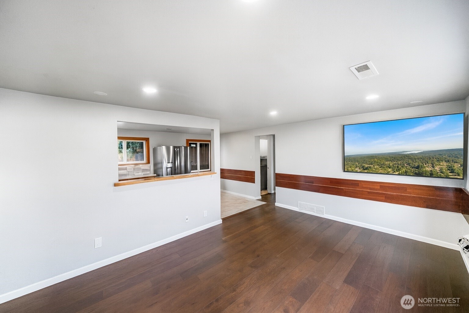4908 236th Street Southwest Mountlake Terrace, WA 98043 - Photo 9 of 21 a view of an empty room with wooden floor and a window