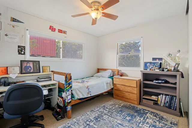 a bedroom with furniture and a book shelf