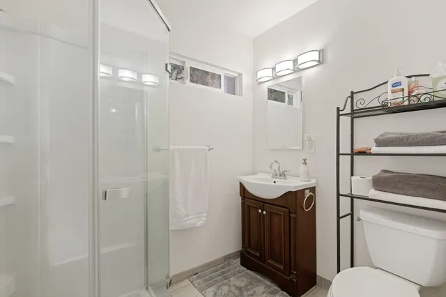 a bathroom with a sink toilet and shower