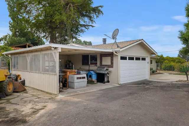 a front view of a house with basket ball court and a garage