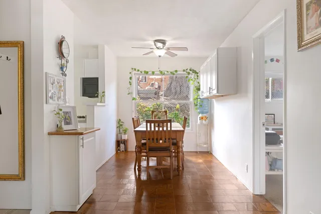 a view of a dining room with furniture a chandelier and wooden floor