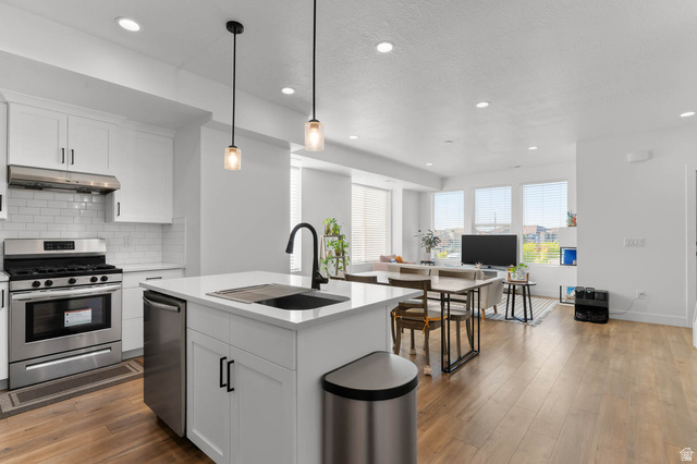 8307 Durham Street Sandy, UT 84070 - Photo 7 of 29 Open-concept living area with wood-finish flooring, recessed lighting, and ample natural light