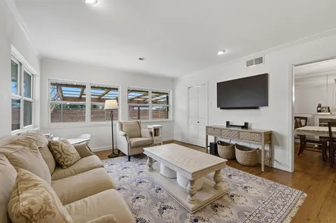 a living room with furniture a rug and a flat screen tv
