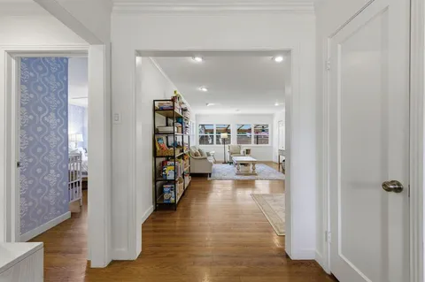 a living room with furniture and a book shelf