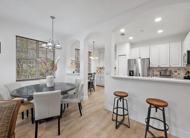 a dining room with furniture and window
