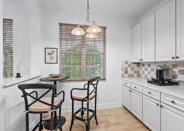 a kitchen with granite countertop white cabinets and white appliances