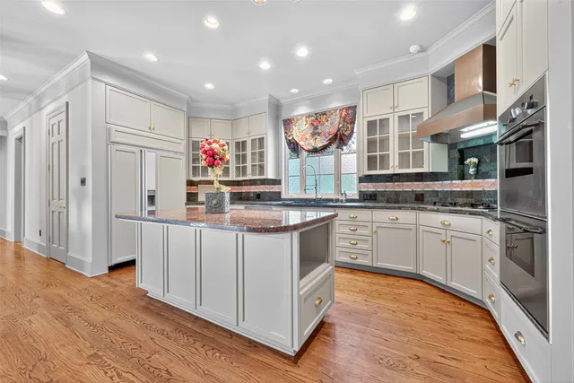a kitchen with stainless steel appliances granite countertop a stove and a refrigerator