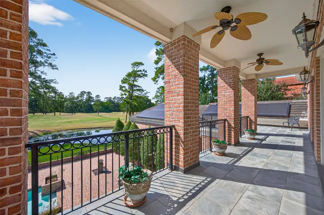 a aerial view of a house with a yard and large trees