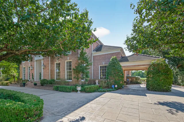 a front view of a house with a yard and a garage