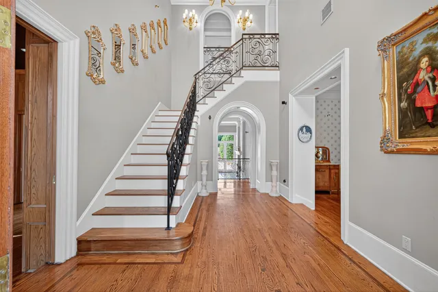 a view of entryway and hall with wooden floor