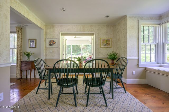 a dining room with furniture and wooden floor