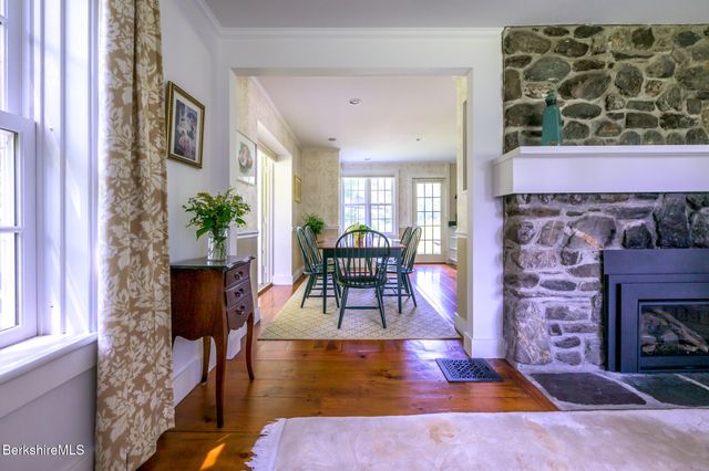 a living room with furniture wooden floor and a fireplace