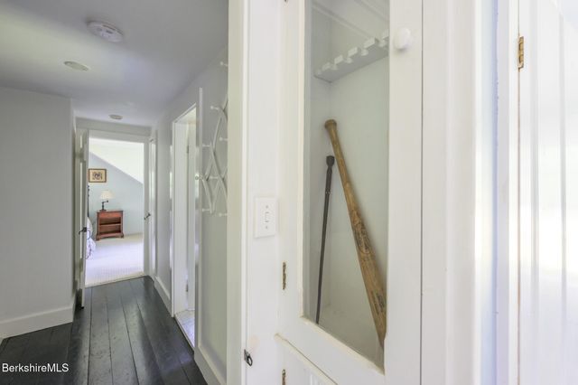 a view of a hallway with a livingroom and furniture