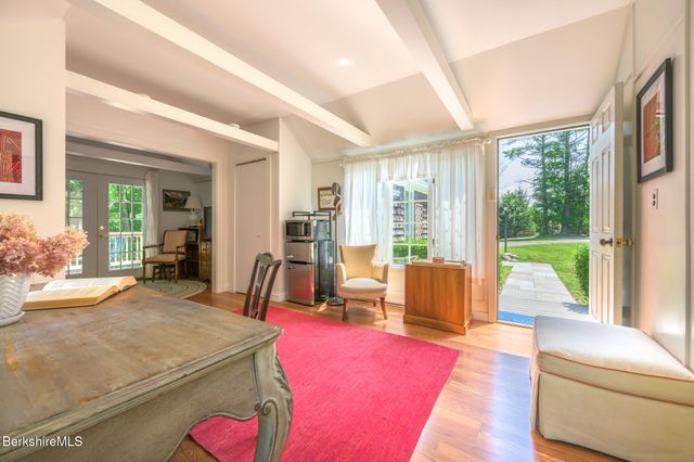 a living room with furniture and large windows