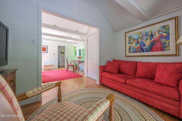 a spacious bedroom with a bed and glass window