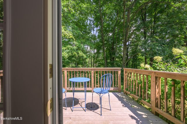 a view of balcony with wooden floor and outdoor seating