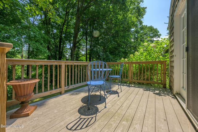 a view of balcony with wooden floor and outdoor seating