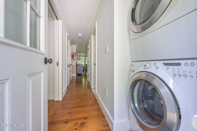 a view of a hallway with washer and dryer