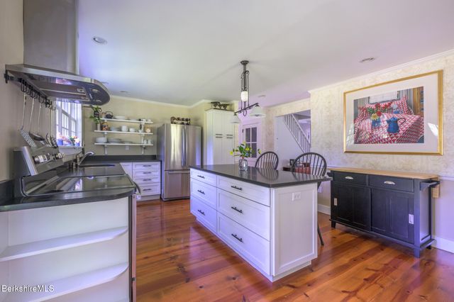 a kitchen with stainless steel appliances granite countertop a sink and a stove