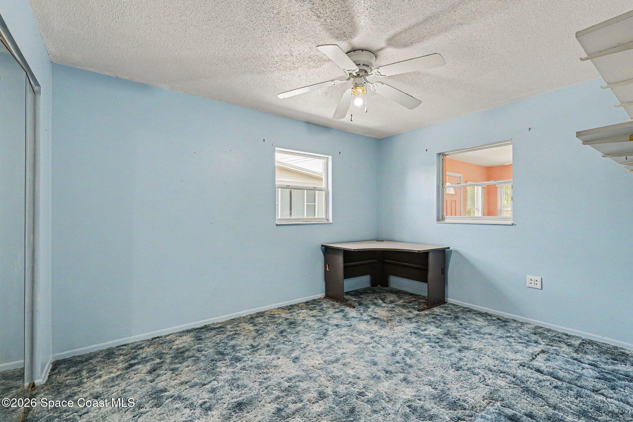 1671 Rice Avenue Titusville, FL 32796 - Photo 16 of 23 a view of room with window and ceiling fan