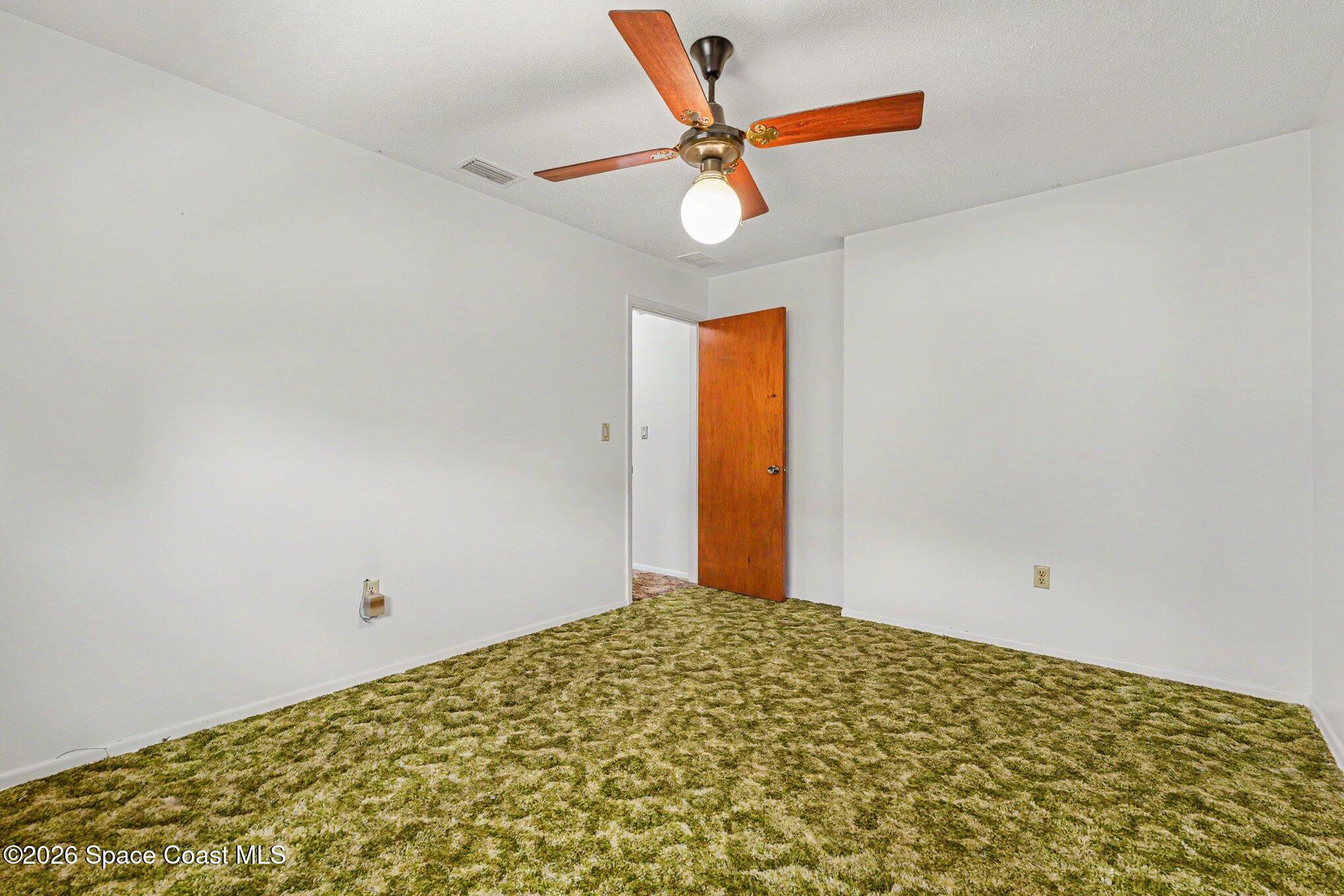 1671 Rice Avenue Titusville, FL 32796 - Photo 17 of 23 a bedroom with a bed and a chandelier