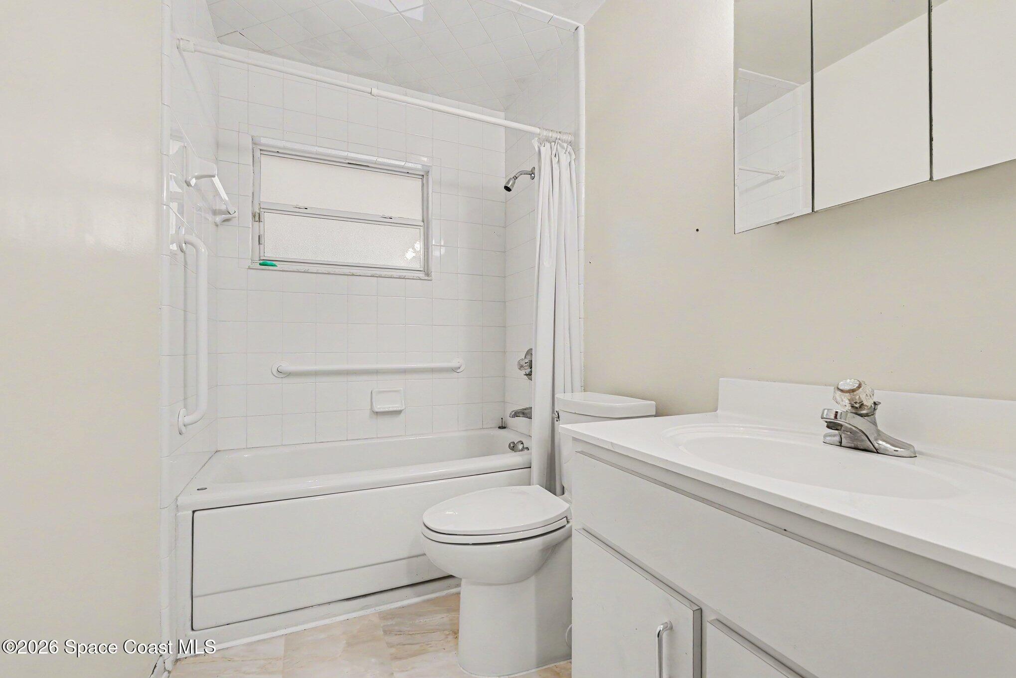 1671 Rice Avenue Titusville, FL 32796 - Photo 19 of 23 a bathroom with a sink a toilet and shower