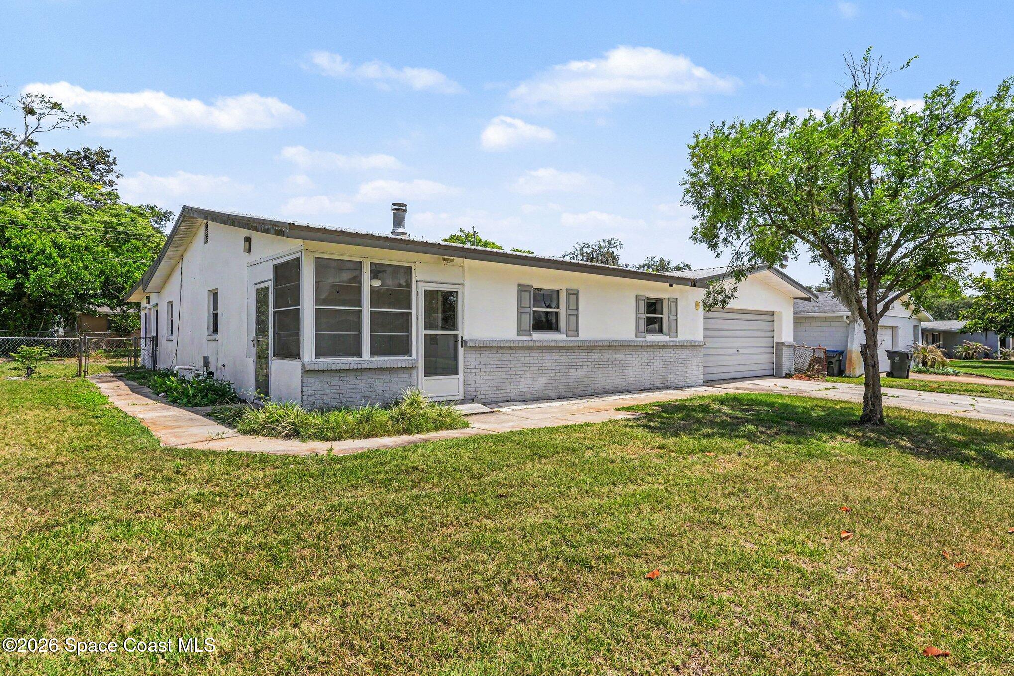 1671 Rice Avenue Titusville, FL 32796 - Photo 2 of 23 a view of a house with a backyard