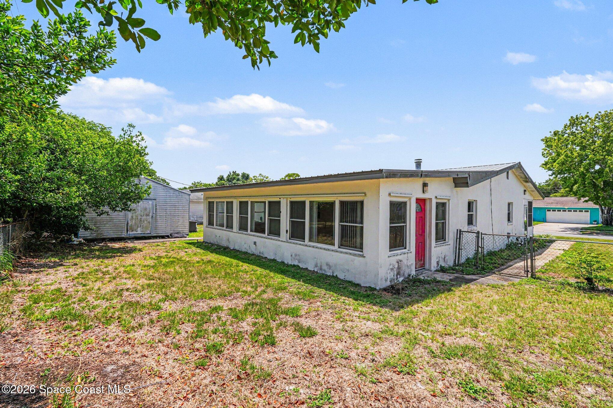 1671 Rice Avenue Titusville, FL 32796 - Photo 21 of 23 a view of a house with a yard and sitting area