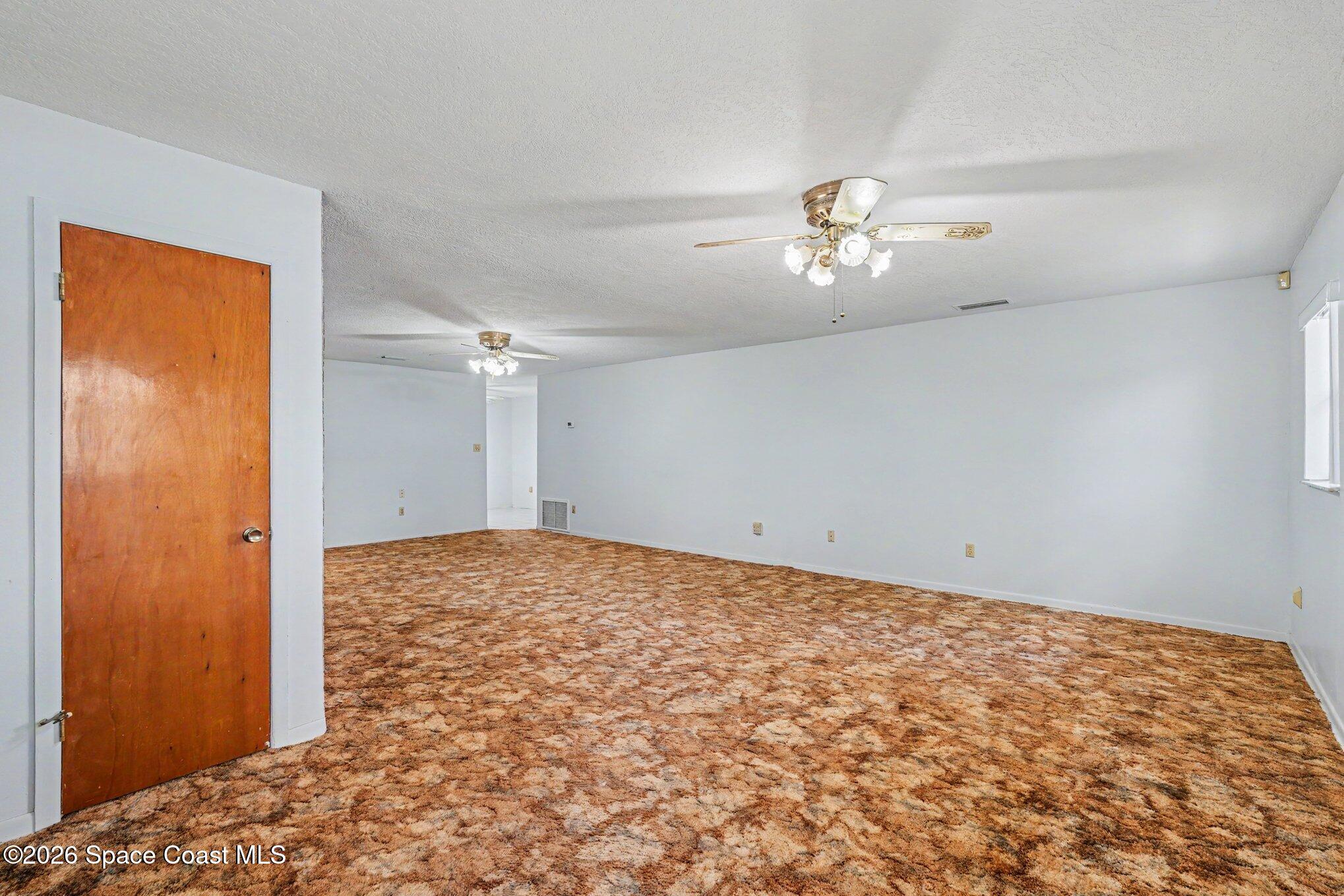 1671 Rice Avenue Titusville, FL 32796 - Photo 3 of 23 a view of empty room with ceiling fan