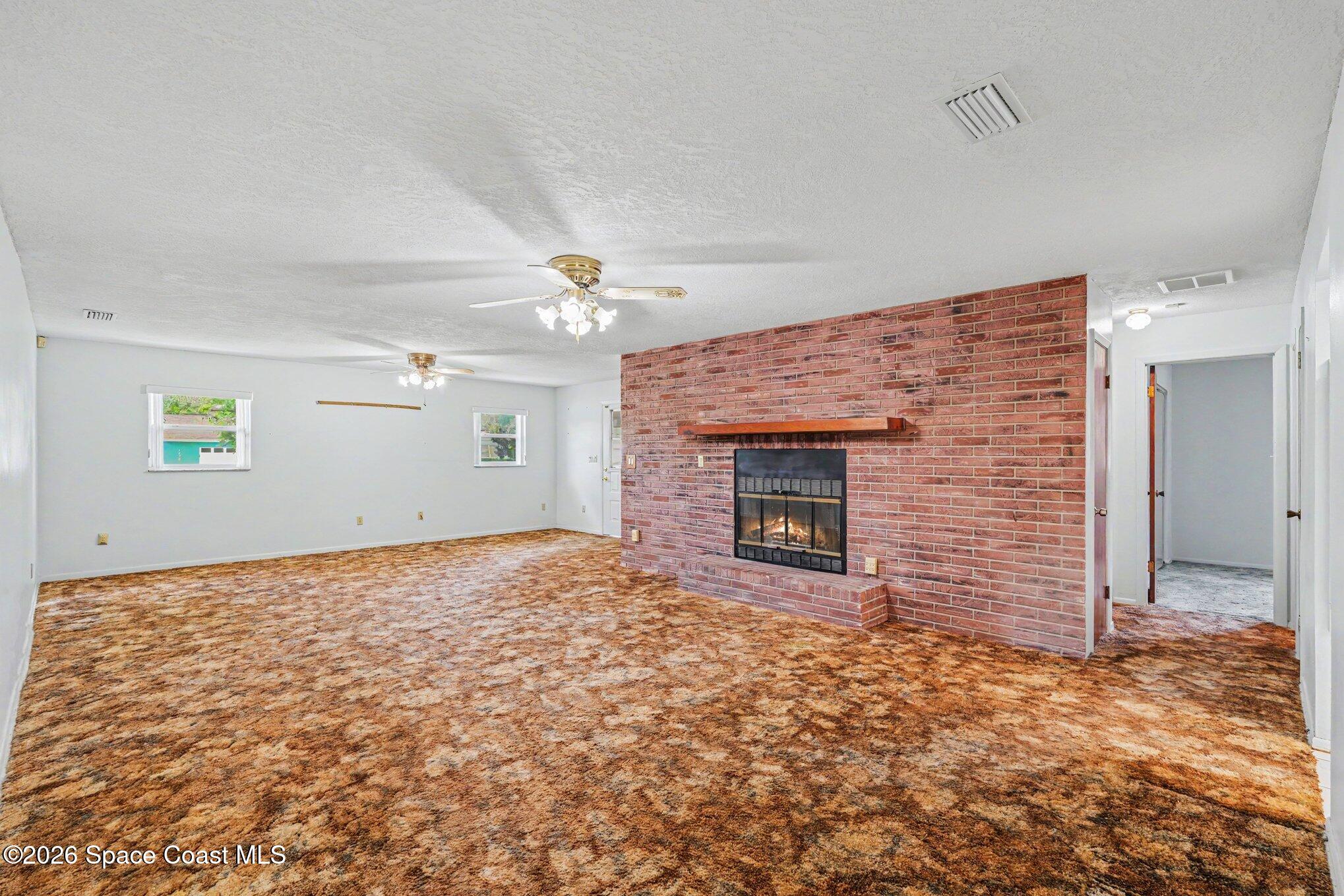 1671 Rice Avenue Titusville, FL 32796 - Photo 5 of 23 a view of empty room with a fireplace