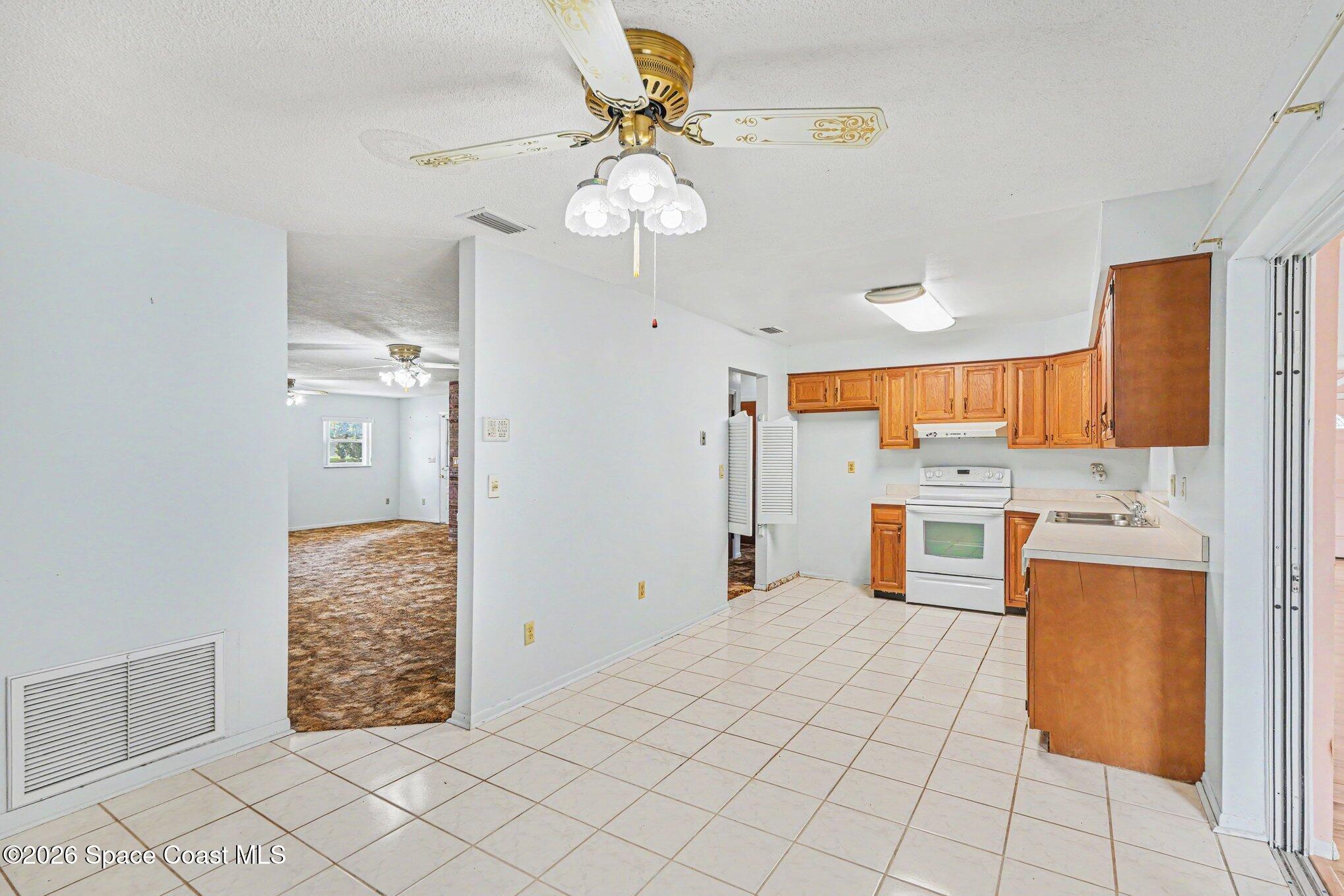 1671 Rice Avenue Titusville, FL 32796 - Photo 6 of 23 a view of kitchen with windows