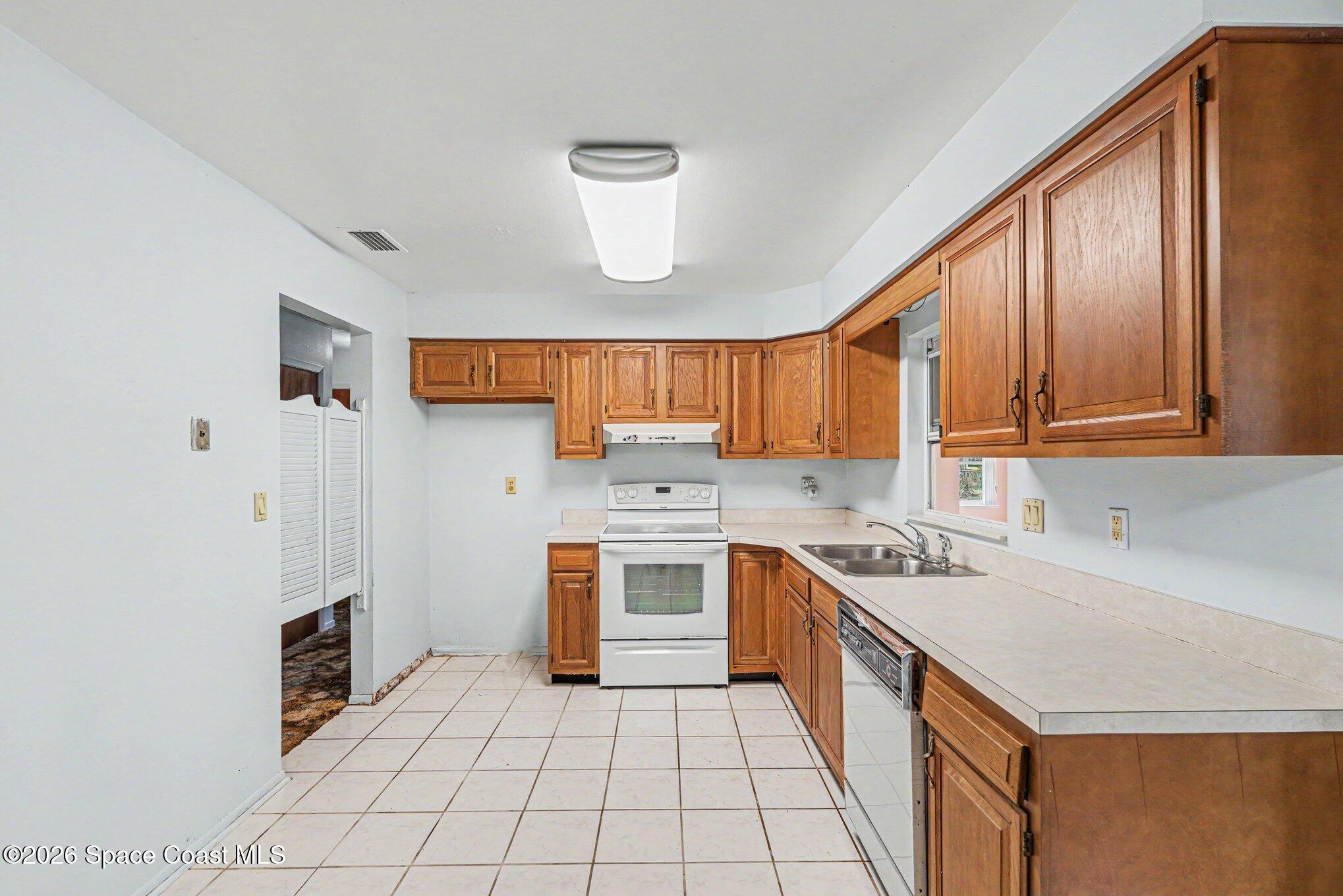 1671 Rice Avenue Titusville, FL 32796 - Photo 7 of 23 a kitchen with a sink stove and cabinets
