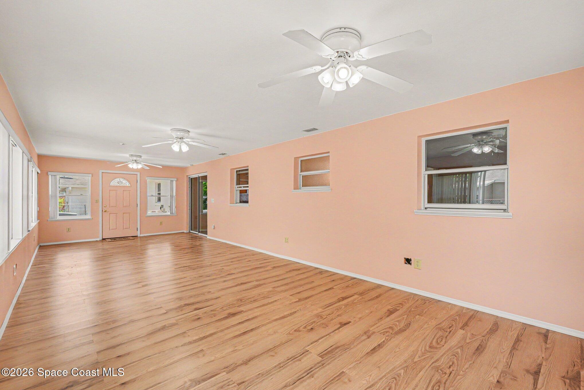 1671 Rice Avenue Titusville, FL 32796 - Photo 10 of 23 a view of an empty room with window and wooden floor