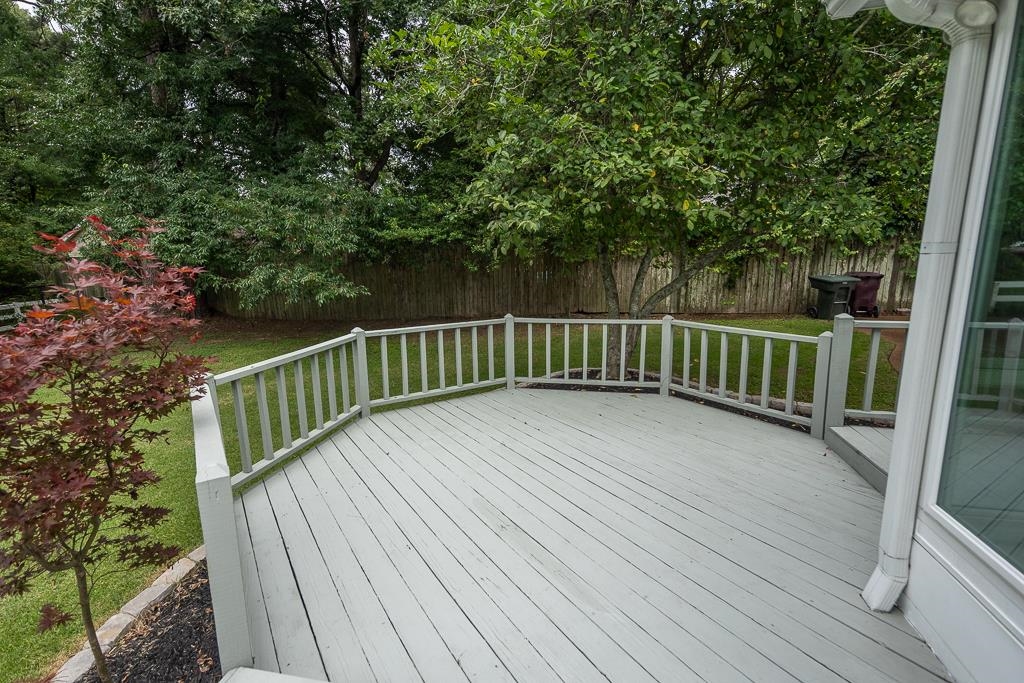 670 Peterson Lake Road Collierville, TN 38017 - Photo 35 of 37 Spacious outdoor deck with painted wood railing overlooking a private backyard with mature trees