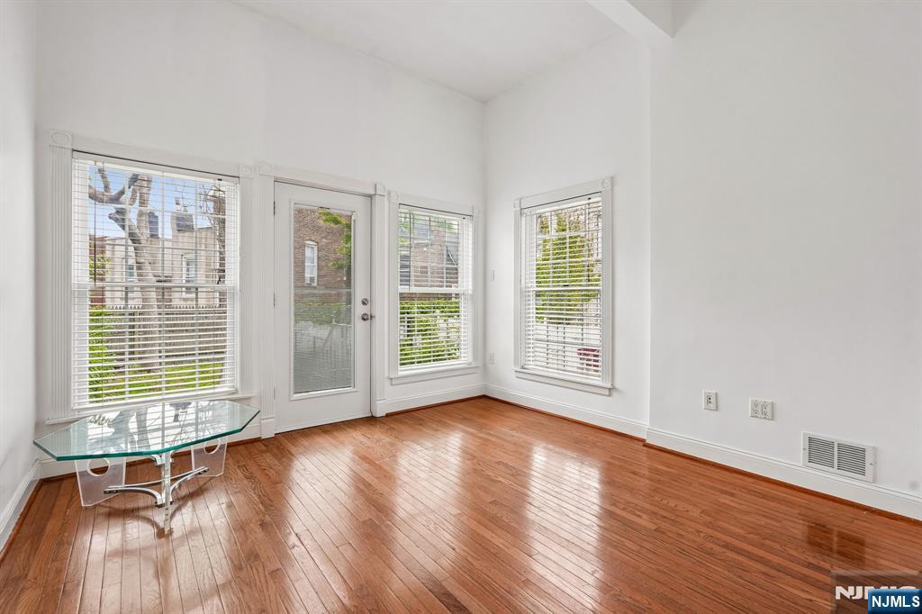 90 A Hackensack Plank Road Weehawken, NJ 07086 - Photo 10 of 40 a view of an empty room with wooden floor and a window