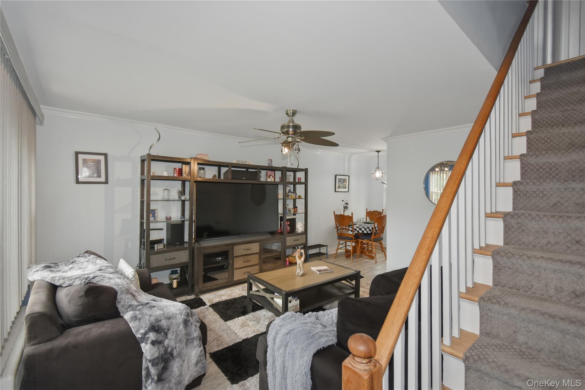 737 Tuckahoe Road, Unit 23 Yonkers, NY 10710 - Photo 6 of 13 a living room with furniture and a flat screen tv
