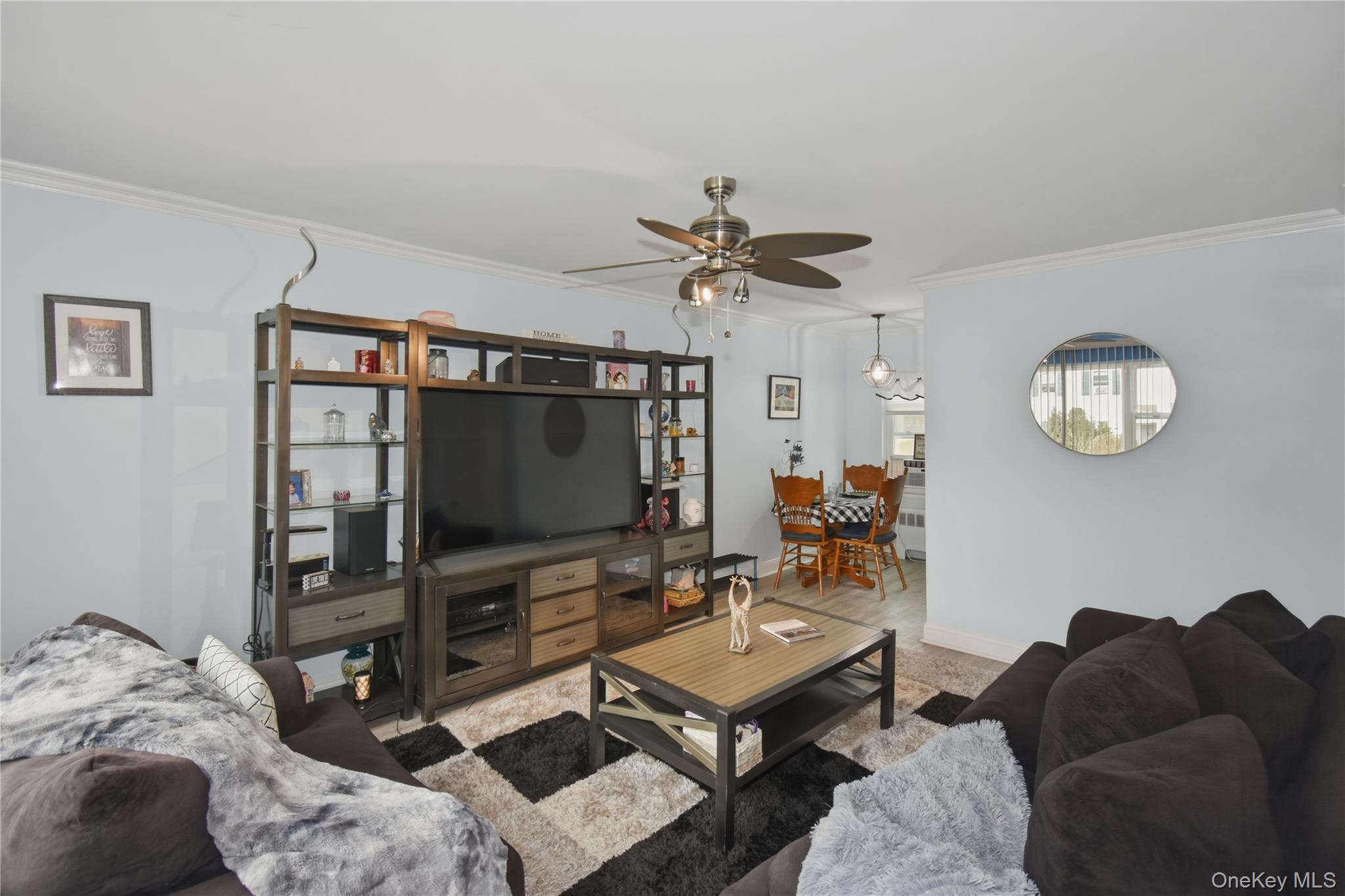 737 Tuckahoe Road, Unit 23 Yonkers, NY 10710 - Photo 7 of 13 a living room with furniture and a flat screen tv