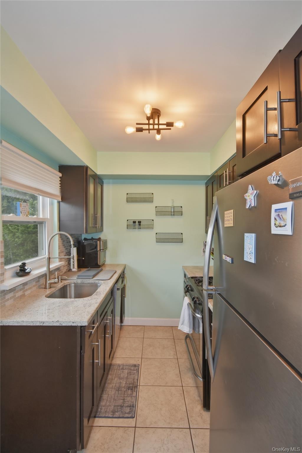 737 Tuckahoe Road, Unit 23 Yonkers, NY 10710 - Photo 10 of 13 a kitchen with stainless steel appliances granite countertop a sink stove and refrigerator