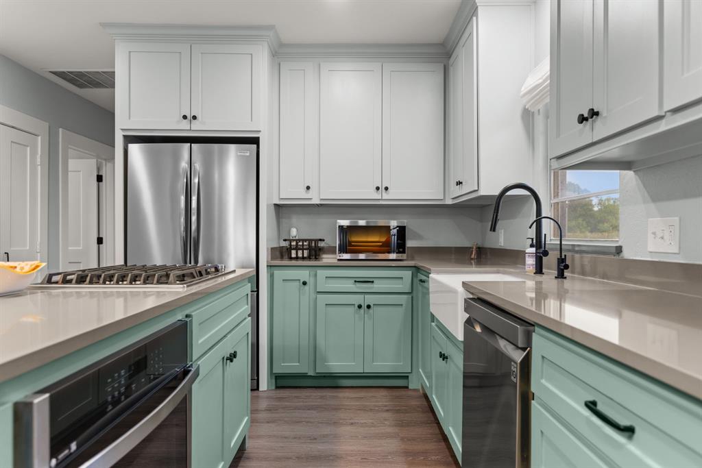 300 Grellhesl Road West, TX 76691 - Photo 11 of 35 a kitchen with stainless steel appliances granite countertop a sink stove and cabinets