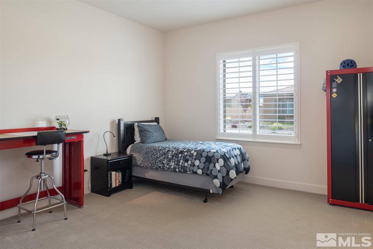 9840 Gainsborough Lane Reno, NV 89521 - Photo 17 of 24 a bedroom with a bed and a chair