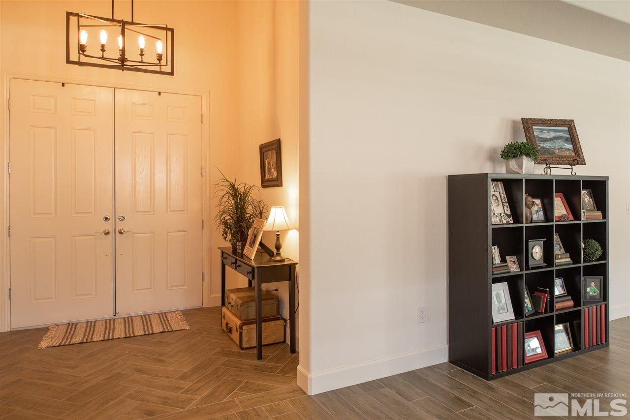 9840 Gainsborough Lane Reno, NV 89521 - Photo 9 of 24 a view of a hallway with wooden floor and cabinet